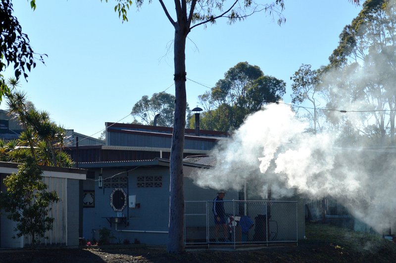DSC_0119crop.jpg - (SCRS) stoking the wood fired water heater for morning showers